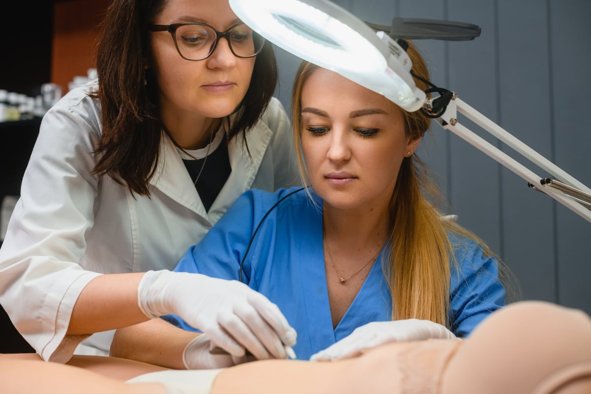 Beautician teach intern how to make electrolysis hair removal in spa beauty salon