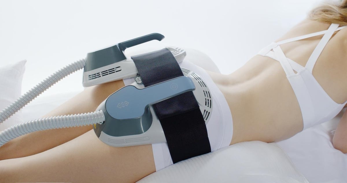 Woman receiving ultrasound therapy treatment on her arm with a medical handheld device